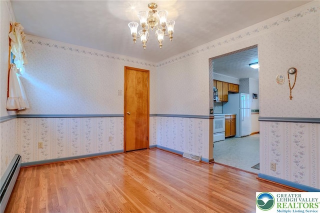 unfurnished room featuring baseboard heating, wallpapered walls, and light wood-style flooring