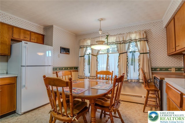 dining space with ornamental molding, wallpapered walls, and a baseboard radiator
