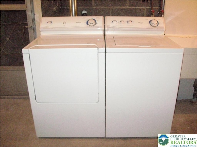 washroom featuring separate washer and dryer and laundry area