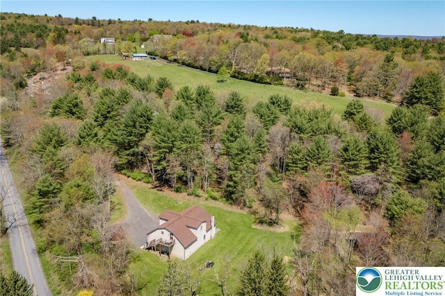birds eye view of property featuring a view of trees
