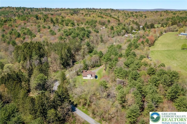 birds eye view of property with a wooded view