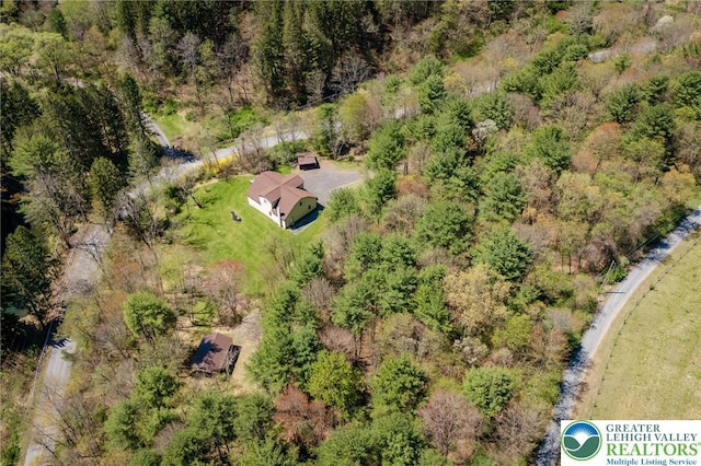 birds eye view of property with a view of trees