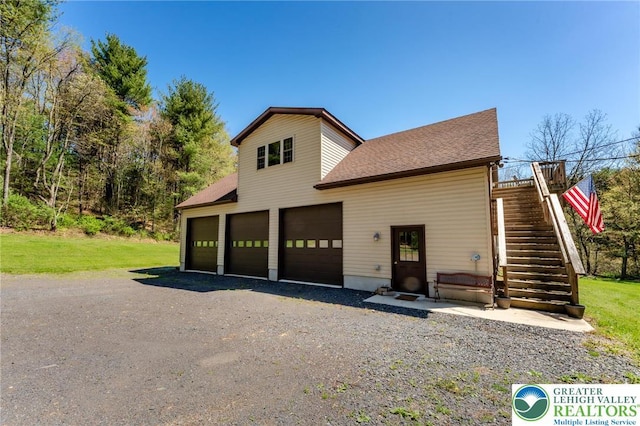 view of front of property with stairs and roof with shingles