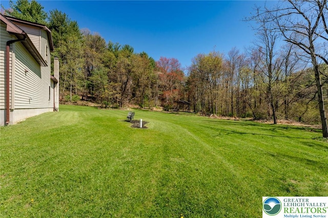view of yard featuring a view of trees