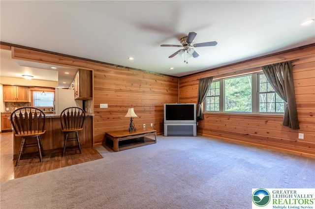 interior space featuring recessed lighting, wood walls, ceiling fan, and a healthy amount of sunlight