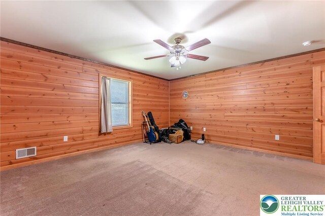exercise area with carpet, wood walls, and visible vents