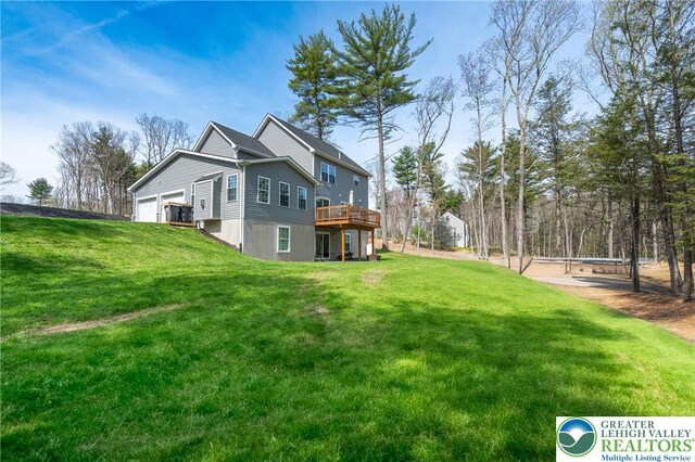131 Chinaberry Way, Polk Twp, PA 18058 - view of side of home with a lawn, a wooden deck, and a garage