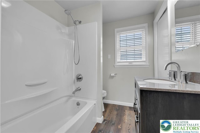 full bath featuring a healthy amount of sunlight, vanity, toilet, and wood finished floors