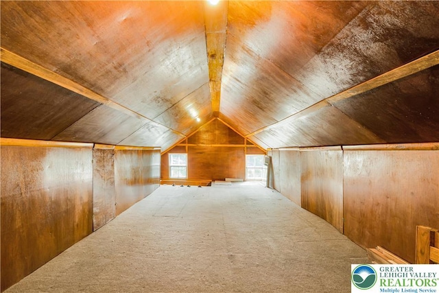 additional living space with wood ceiling, vaulted ceiling, wood walls, and carpet flooring