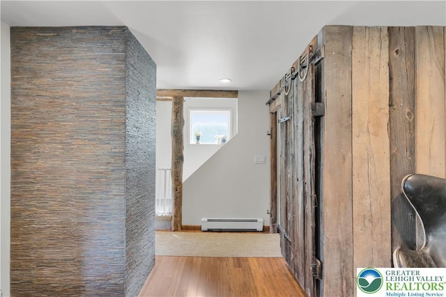 hallway featuring a baseboard heating unit, recessed lighting, and hardwood / wood-style floors
