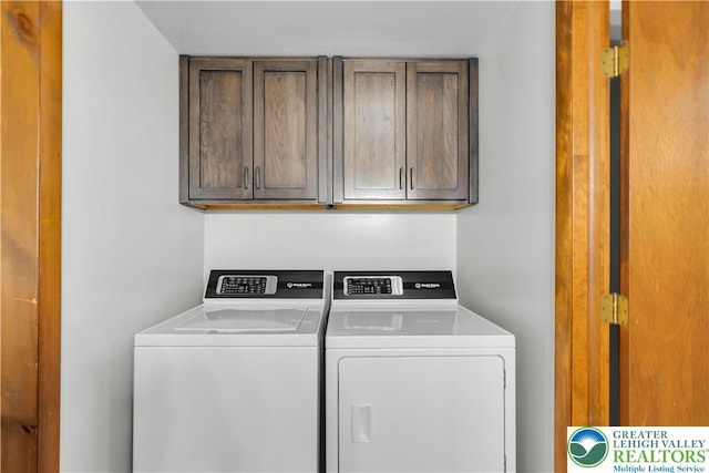 laundry room with cabinet space and separate washer and dryer