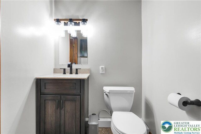 bathroom with toilet and vanity