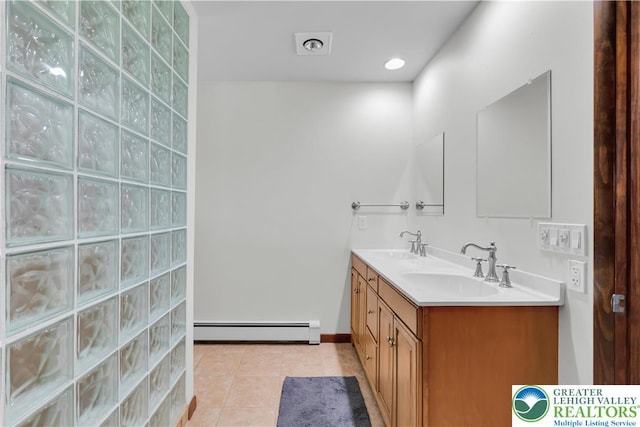 full bath with a sink, tile patterned floors, a baseboard radiator, and double vanity