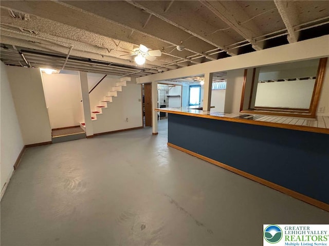 finished basement with baseboards and stairway