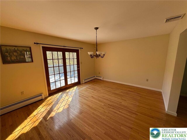 91 Alpine Dr, Jim Thorpe Boro, PA 18229 - unfurnished dining area with a baseboard heating unit, wood finished floors, a chandelier, and french doors
