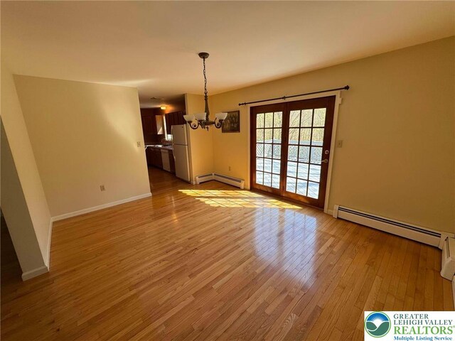 91 Alpine Dr, Jim Thorpe Boro, PA 18229 - unfurnished dining area with baseboard heating, a chandelier, and light wood-style floors