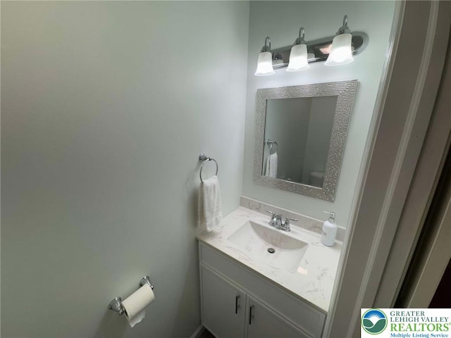 bathroom with vanity and toilet