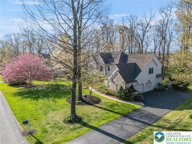 8750 Summit Cir, Weisenberg Twp, PA 18051 - view of front of property featuring a garage, driveway, a front lawn, and stone siding