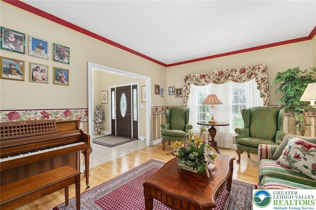 living room with ornamental molding and light wood-style flooring