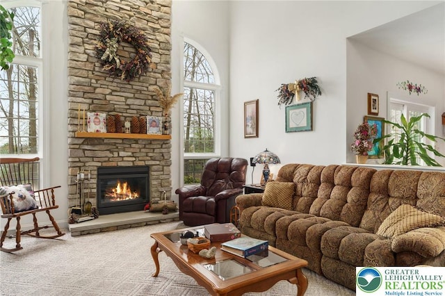 living room featuring a towering ceiling and a fireplace