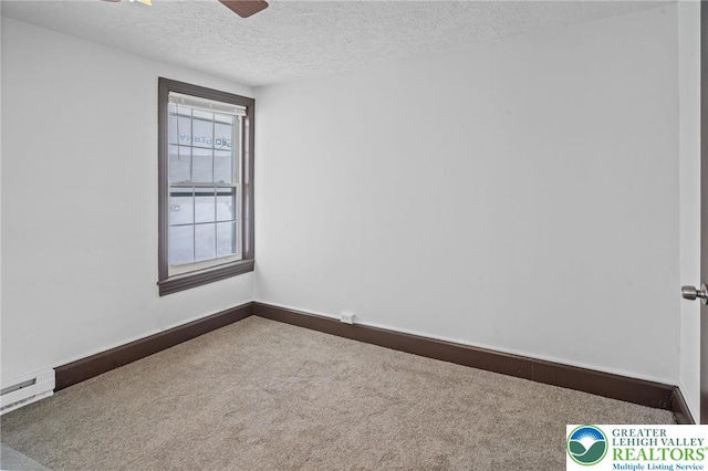 carpeted empty room with baseboards, a textured ceiling, and ceiling fan
