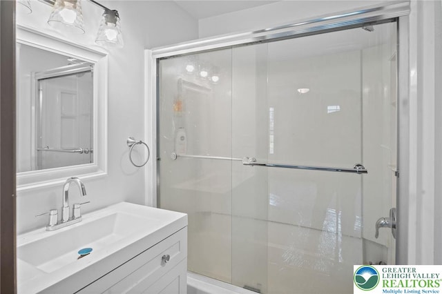 bathroom with vanity and a stall shower