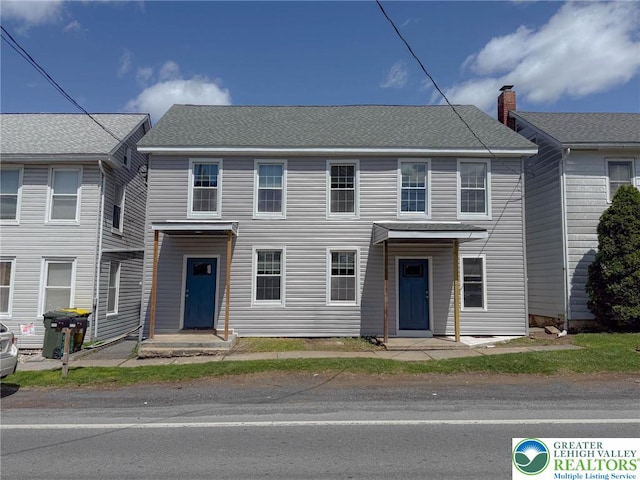 townhome / multi-family property with a chimney