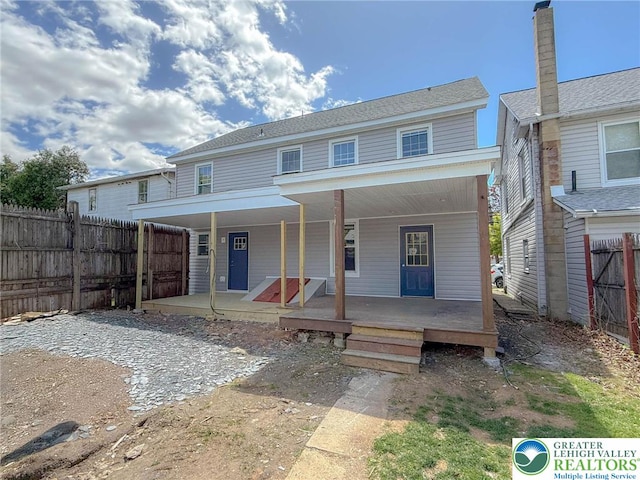 view of front facade with a porch and fence