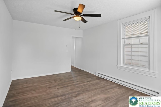 empty room featuring ceiling fan, a textured ceiling, baseboards, wood finished floors, and a baseboard heating unit