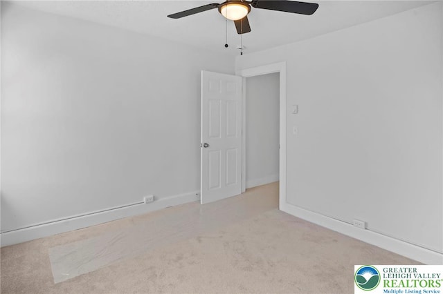 unfurnished room featuring carpet floors, ceiling fan, and baseboards