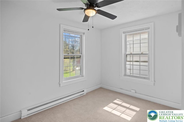 empty room featuring baseboard heating, a ceiling fan, and light colored carpet