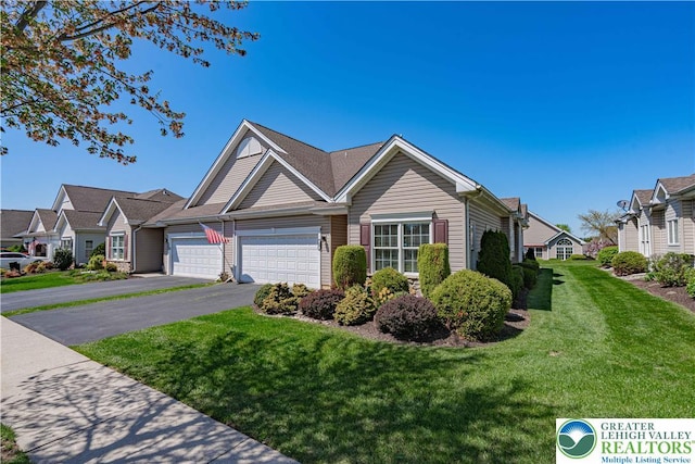 single story home featuring driveway, a front yard, and a garage