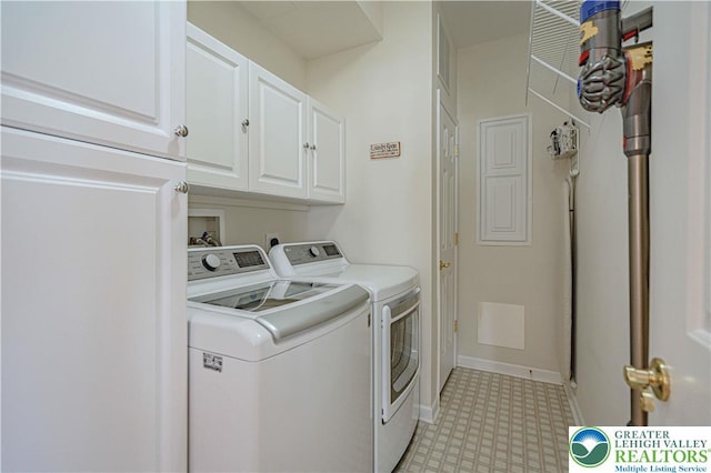 laundry area with light floors, baseboards, cabinet space, and washer and clothes dryer
