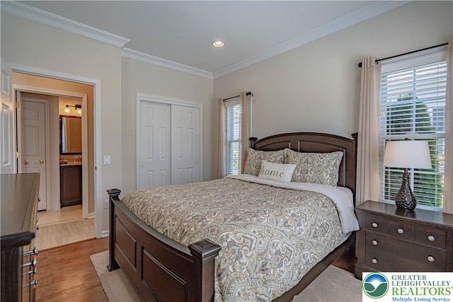 bedroom featuring ornamental molding, a closet, recessed lighting, and light wood-style flooring