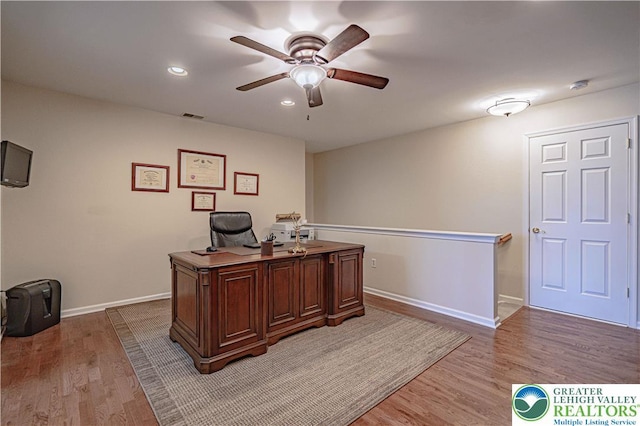 office area with a ceiling fan, baseboards, visible vents, and light wood-style flooring