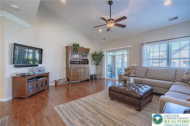 living area with visible vents, ceiling fan, wood finished floors, and high vaulted ceiling