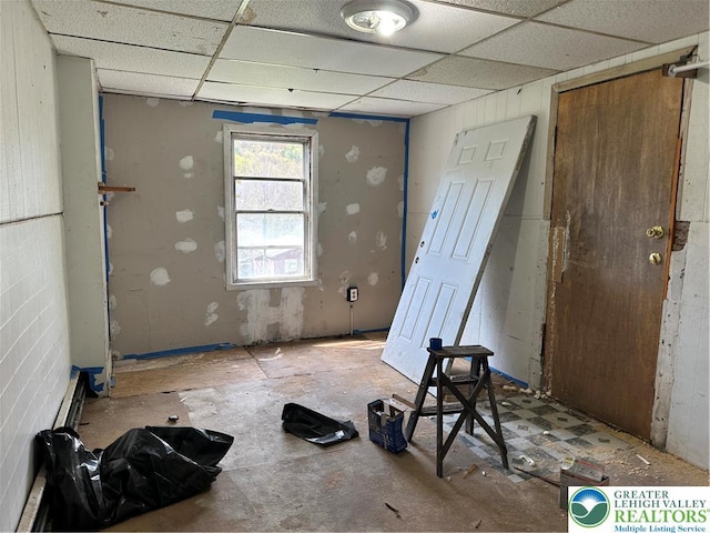 unfurnished room with a drop ceiling