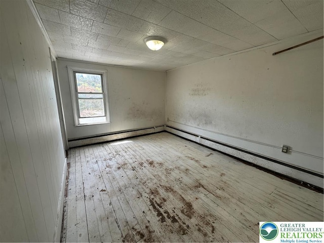unfurnished room with wood-type flooring