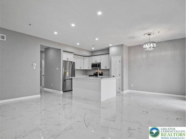 kitchen with white cabinets, appliances with stainless steel finishes, recessed lighting, baseboards, and open floor plan