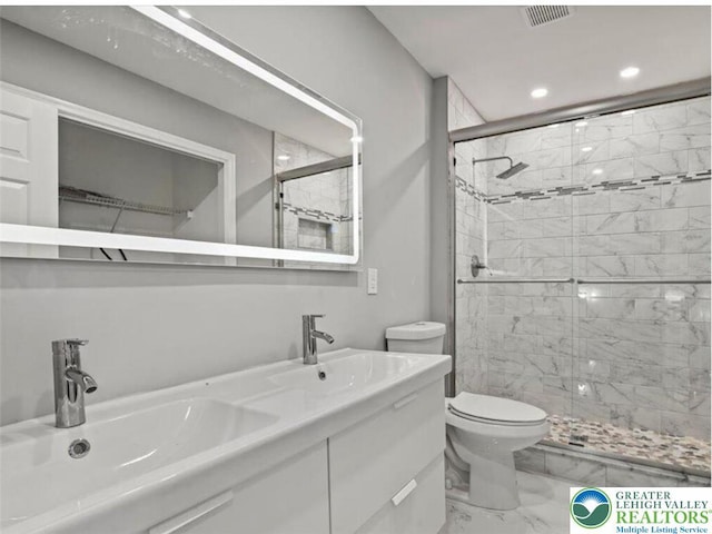 full bath featuring marble finish floor, toilet, recessed lighting, a sink, and a stall shower