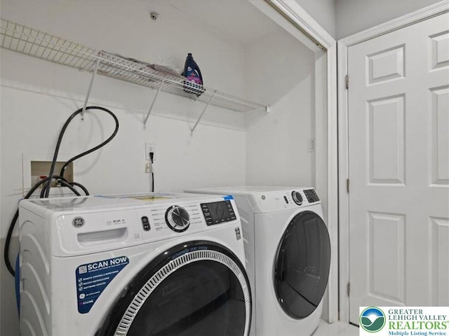 clothes washing area with laundry area and washer and clothes dryer