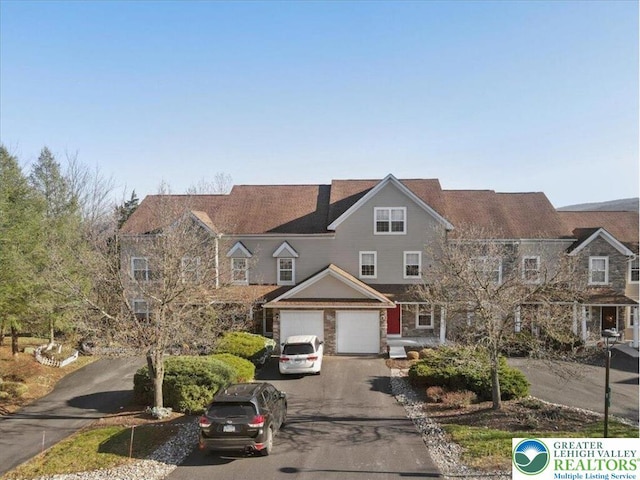 townhome / multi-family property featuring driveway