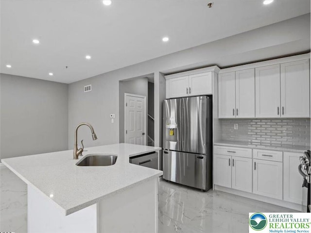 kitchen featuring stainless steel fridge, a sink, marble finish floor, and recessed lighting