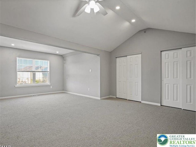 unfurnished bedroom featuring vaulted ceiling, carpet floors, two closets, and recessed lighting
