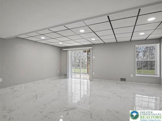 empty room featuring recessed lighting, a wealth of natural light, marble finish floor, and visible vents