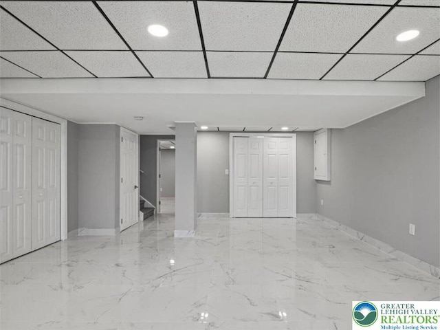 finished basement with stairs, recessed lighting, baseboards, and marble finish floor