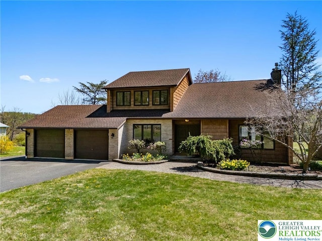 view of front of property featuring roof with shingles, an attached garage, a front lawn, aphalt driveway, and a chimney