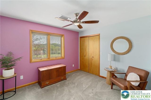 living area with baseboards, ceiling fan, carpet flooring, and visible vents