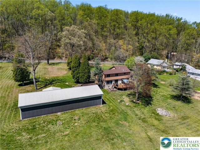 birds eye view of property with a view of trees
