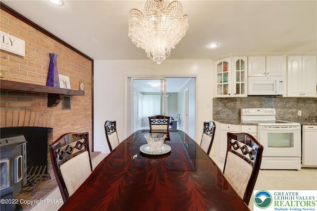 dining space with recessed lighting, light tile patterned flooring, and a notable chandelier